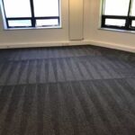 This is a photo of a grey office carpet that has just been professionally steam cleaned works carried out by Chessington Carpet Cleaning