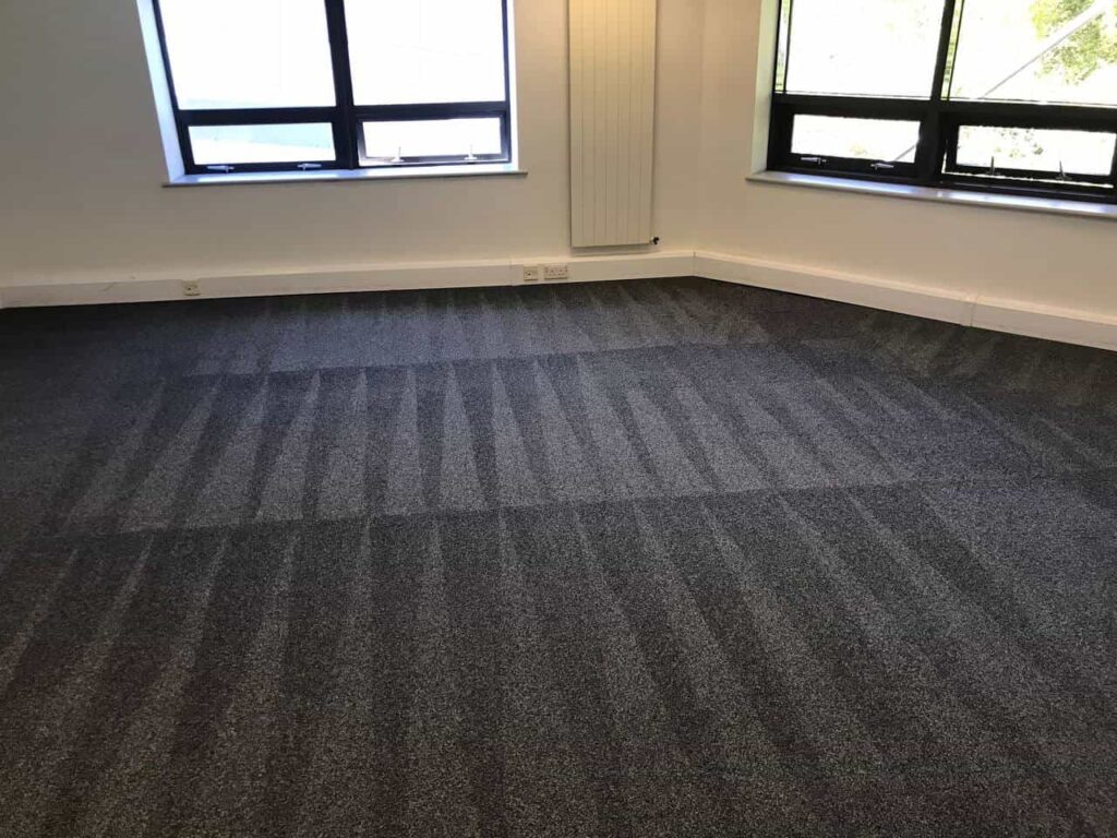 This is a photo of a grey office carpet that has just been professionally steam cleaned works carried out by Chessington Carpet Cleaning