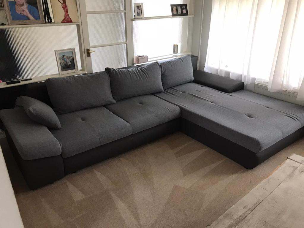 This is a photo of a grey L shape sofa that has been professionally steam cleaned, also the beige carpets have been steam cleaned too works carried out by Chessington Carpet Cleaning