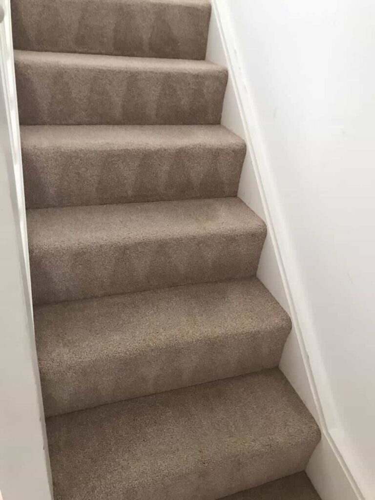 This is an after photo of a staircase with a beige carpet that has been cleaned works carried out by Chessington Carpet Cleaning